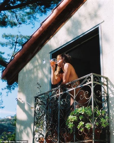 halle berry enjoyed a glass of wine in the nude.|Halle Berry drinks wine naked on her balcony